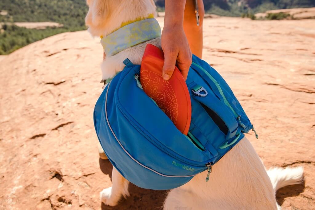 Showing a Ruffwear Camp Flyer folded and stored in a dog backpack